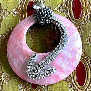 Unusual pink mother of pearl inlay over coconut shell with hematite